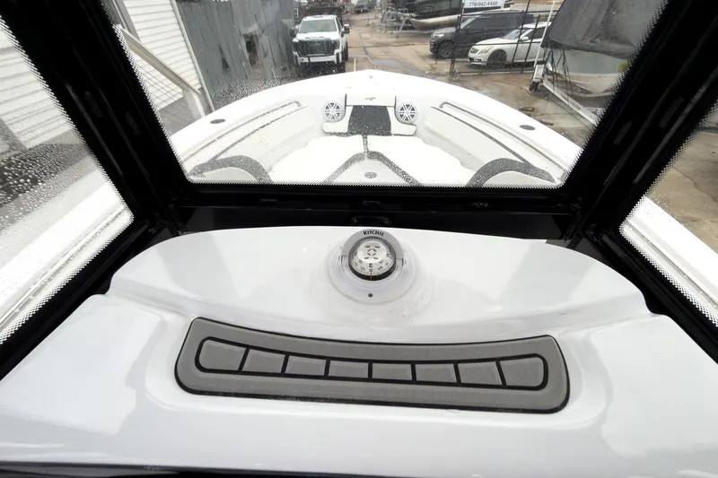 Slide: The Image of 2026 Tidewater 210 LXF boat dashboard with compass and control panel. - 15