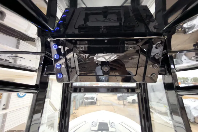 Slide: The Image of Interior view of 2026 Tidewater 210 LXF boat console with control panel and switches. - 16