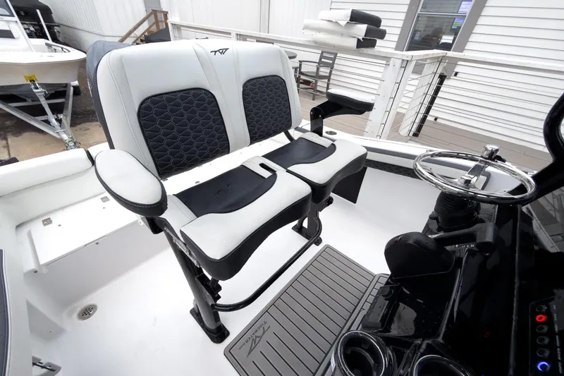 Slide: The Image of 2026 Tidewater 210 LXF boat interior with dual seats and steering wheel. - 17