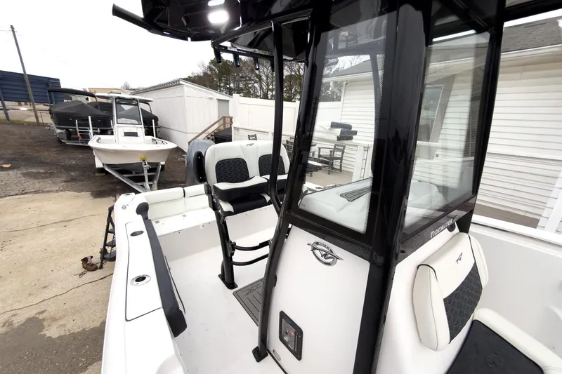 Slide: The Image of 2026 Tidewater 210 LXF boat with sleek design and modern features, docked outdoors. - 19