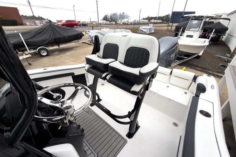 Slide: The Image of 2026 Tidewater 210 LXF boat interior with steering wheel and seating. - 20