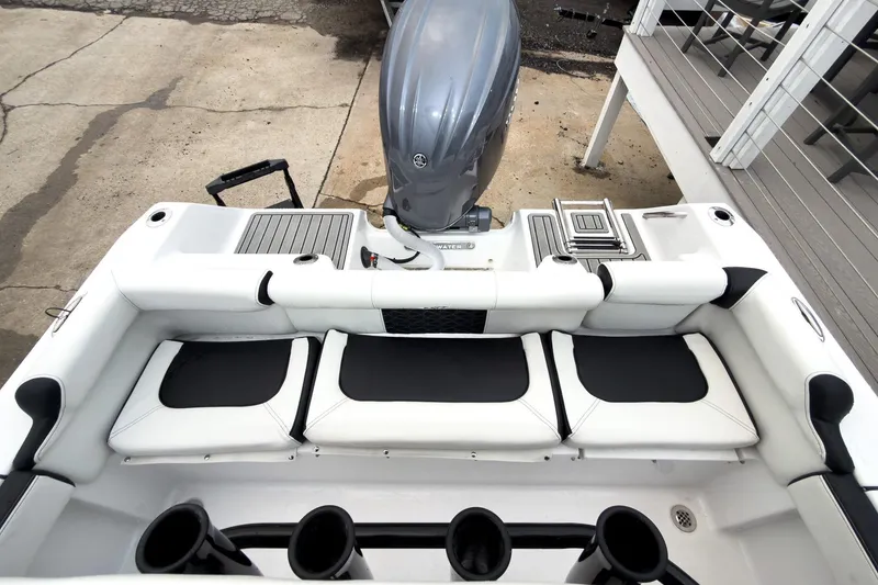 Slide: The Image of 2026 Tidewater 210 LXF boat interior with seating and engine view. - 22