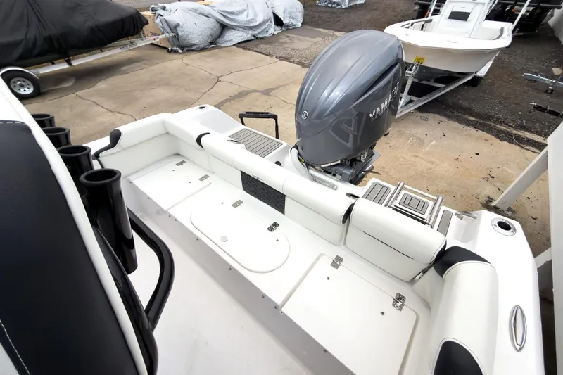 Slide: The Image of 2026 Tidewater 210 LXF boat with Yamaha outboard engine, docked on concrete. - 24
