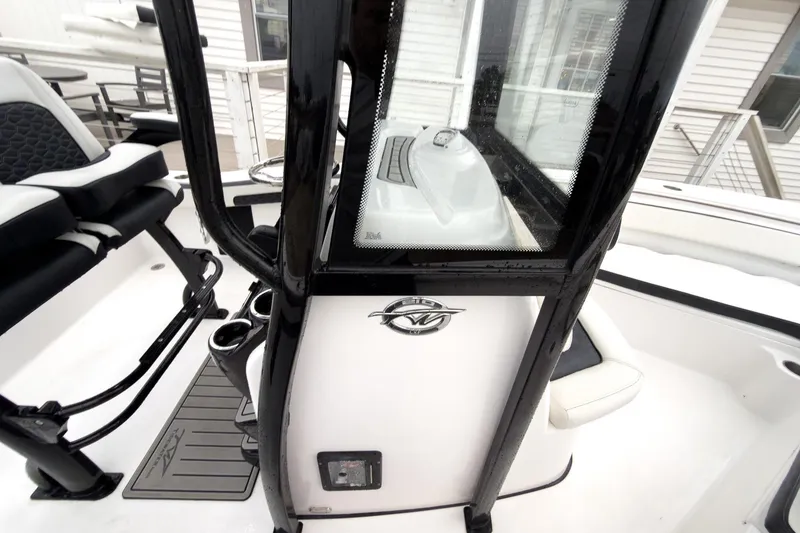 Slide: The Image of 2026 Tidewater 210 LXF boat interior with sleek black and white design. - 26