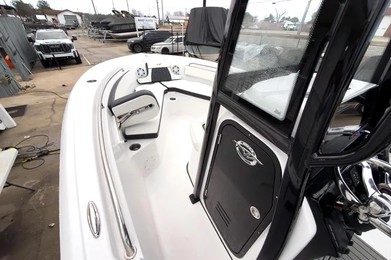 Slide: The Image of 2026 Tidewater 210 LXF boat interior with seating and console, parked at a marina. - 28
