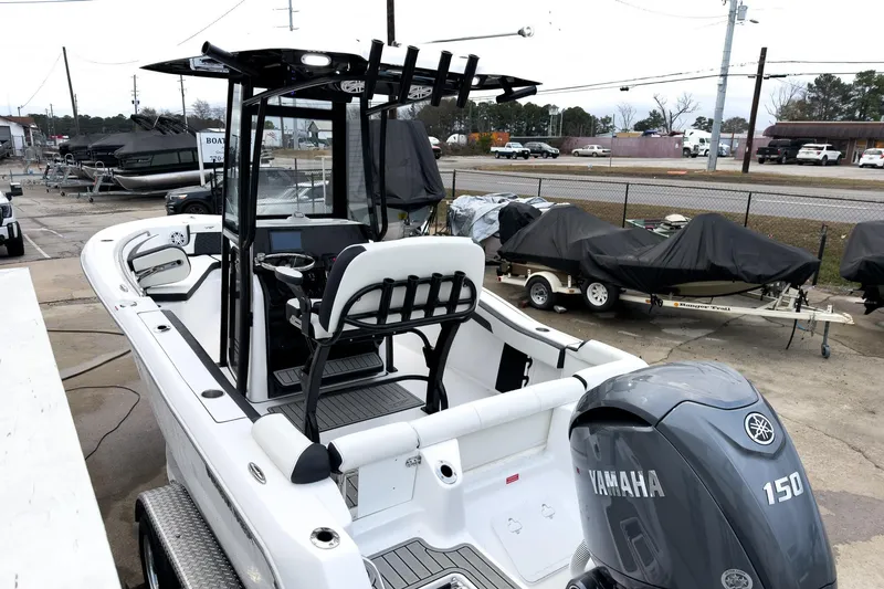 Slide: The Image of 2026 Tidewater 210 LXF boat with Yamaha 150 engine, parked outdoors. - 32