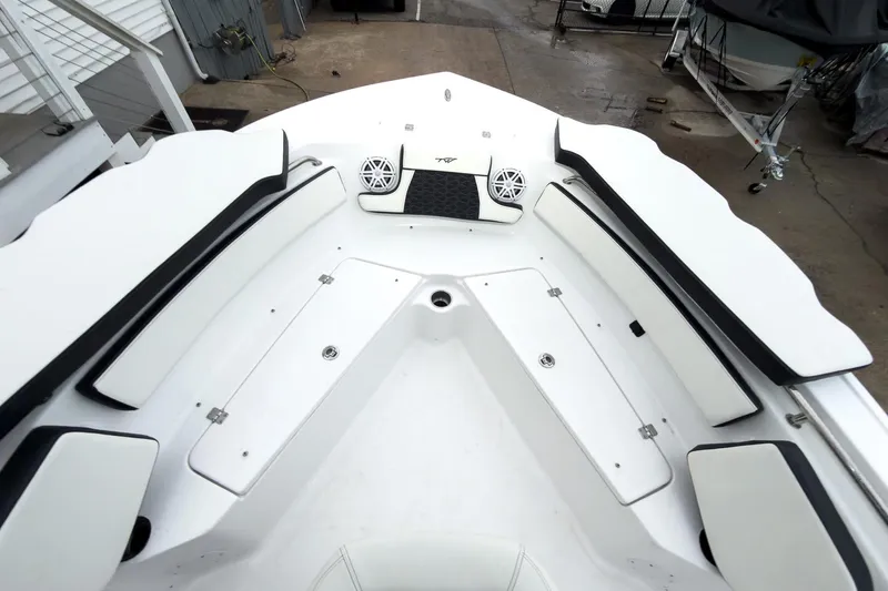 Slide: The Image of 2026 Tidewater 210 LXF boat interior with white seating and storage compartments. - 37