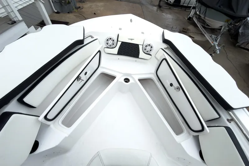 Slide: The Image of 2026 Tidewater 210 LXF boat interior with open storage compartments and speakers. - 38