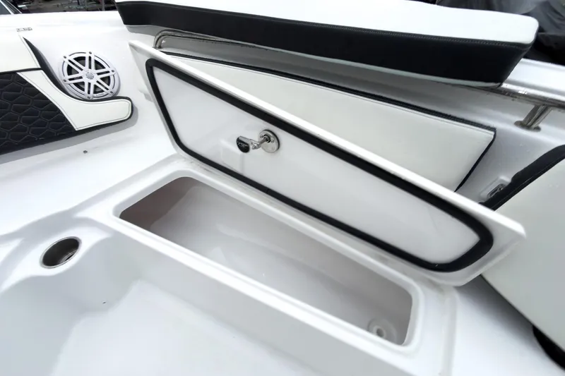 Slide: The Image of 2026 Tidewater 210 LXF boat storage compartment with speaker and cushioned seating. - 39