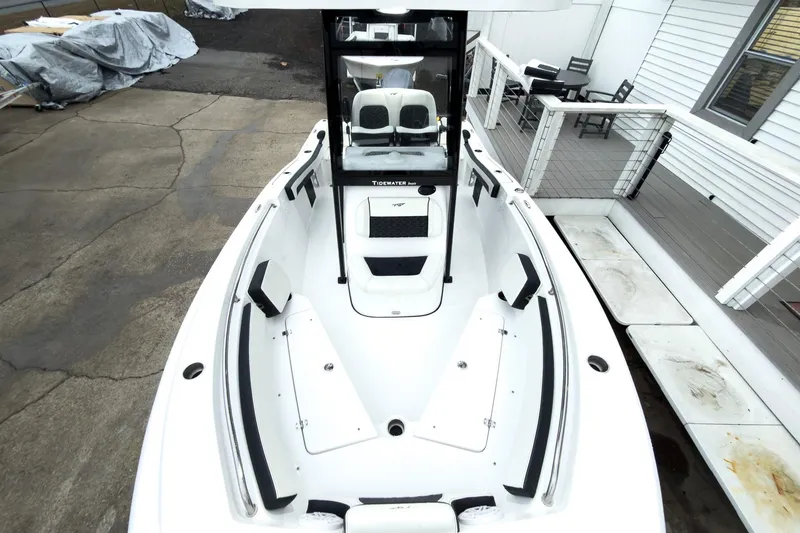 Slide: The Image of 2026 Tidewater 210 LXF boat, white interior, docked near a wooden deck. - 41
