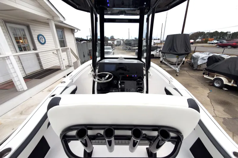 Slide: The Image of 2026 Tidewater 210 LXF boat interior with steering console and rod holders. - 9