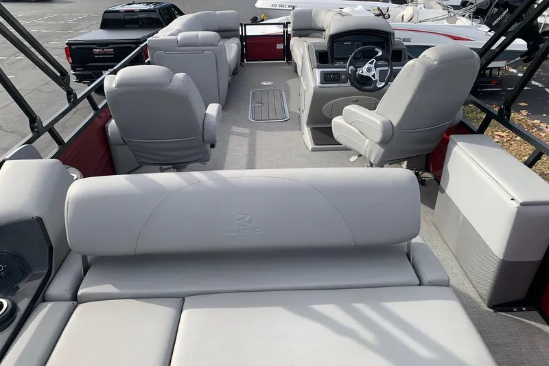 Slide: The Image of 2024 Regency 250DL3 pontoon boat interior with plush seating and modern dashboard. - 3