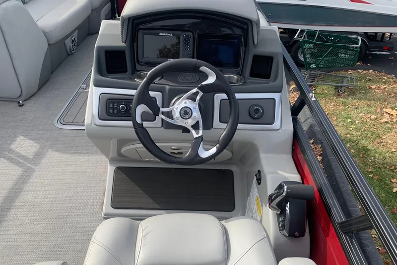 Slide: The Image of 2024 Regency 250DL3 boat helm with steering wheel and navigation system. - 4