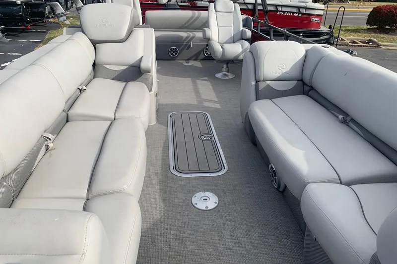 Slide: The Image of 2024 Regency 250DL3 pontoon boat interior with plush gray seating and spacious layout. - 5