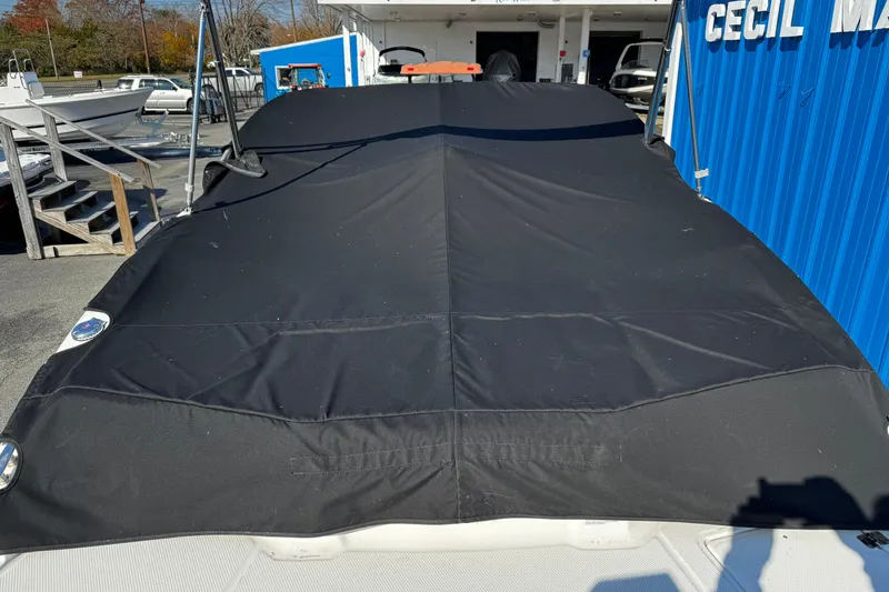 Slide: The Image of 2016 Chaparral 21 H2O Sport boat covered with black tarp at marina. - 10
