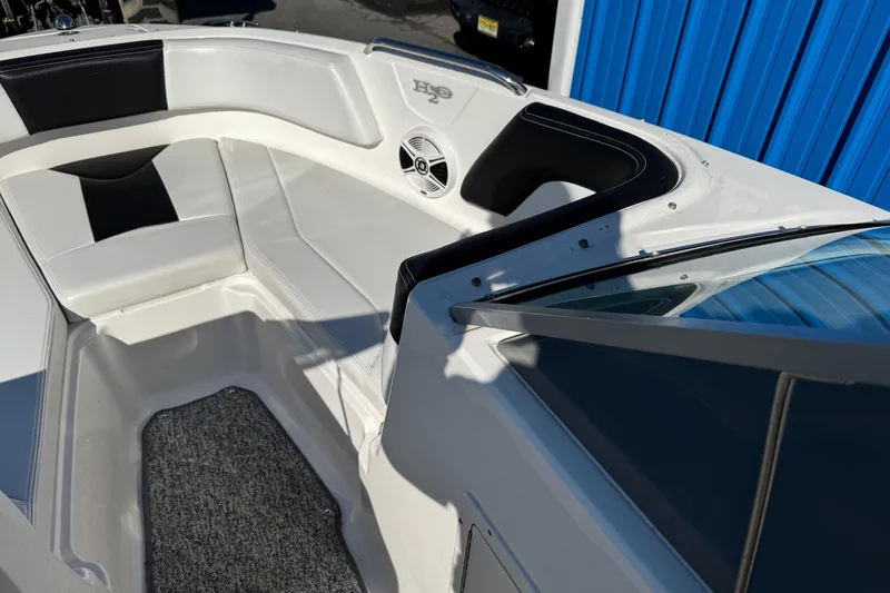 Slide: The Image of 2016 Chaparral 21 H2O Sport boat interior with cushioned seating and speaker. - 12