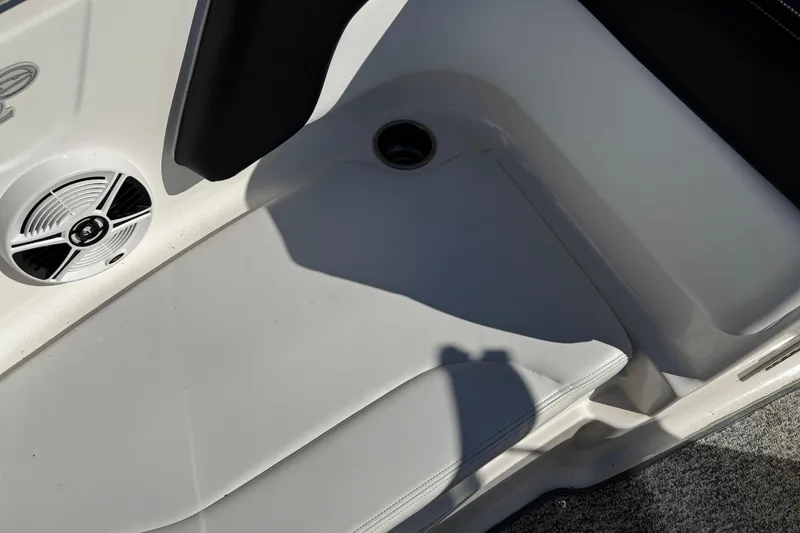 Slide: The Image of 2016 Chaparral 21 H2O Sport interior with speaker and seating area. - 14