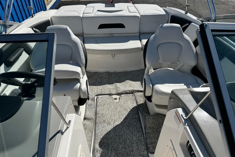 Slide: The Image of 2016 Chaparral 21 H2O Sport boat interior with white seating and carpeted floor. - 15