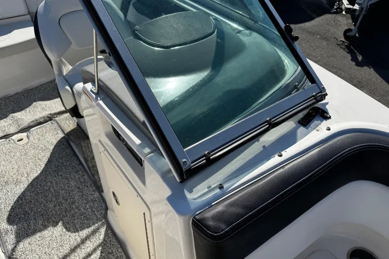 Slide: The Image of 2016 Chaparral 21 H2O Sport boat interior with windshield and seating detail. - 17
