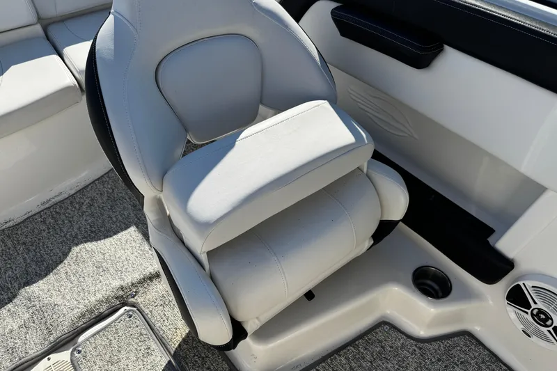 Slide: The Image of 2016 Chaparral 21 H2O Sport boat interior with white cushioned seat and carpeted floor. - 19