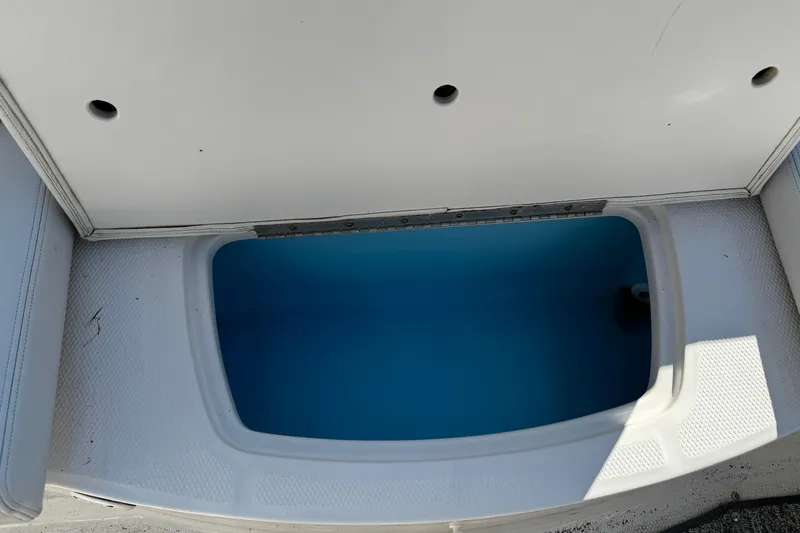 Slide: The Image of 2016 Chaparral 21 H2O Sport boat storage compartment with blue interior. - 24