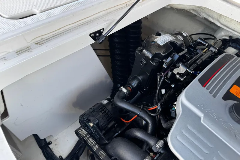Slide: The Image of Engine compartment of a 2016 Chaparral 21 H2O Sport boat, showcasing mechanical components. - 27