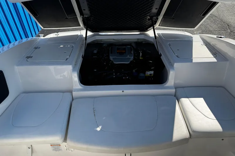 Slide: The Image of 2016 Chaparral 21 H2O Sport boat engine compartment with open hatches. - 30