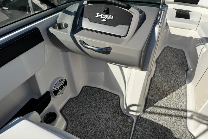 Slide: The Image of 2016 Chaparral 21 H2O Sport boat interior with carpeted flooring and cup holder. - 31
