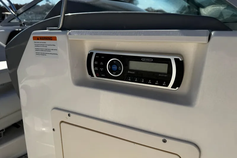 Slide: The Image of 2016 Chaparral 21 H2O Sport boat dashboard with Jensen stereo system. - 34