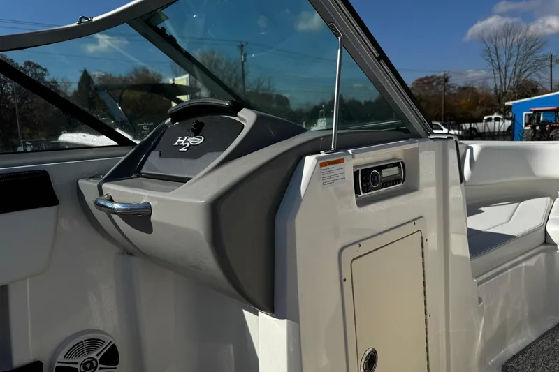 Slide: The Image of 2016 Chaparral 21 H2O Sport boat interior with dashboard and seating. - 38