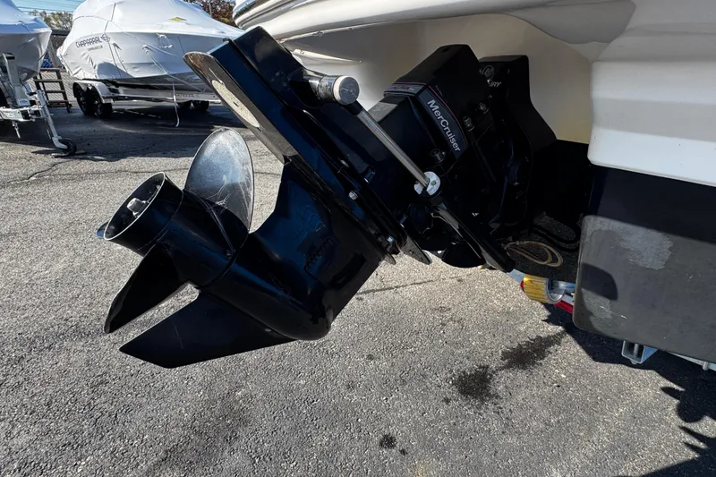 Slide: The Image of 2016 Chaparral 21 H2O Sport boat with MerCruiser outdrive, parked on asphalt. - 5