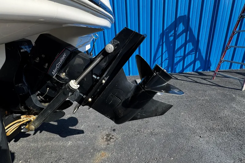 Slide: The Image of 2016 Chaparral 21 H2O Sport boat with MerCruiser outdrive, blue metal wall background. - 6