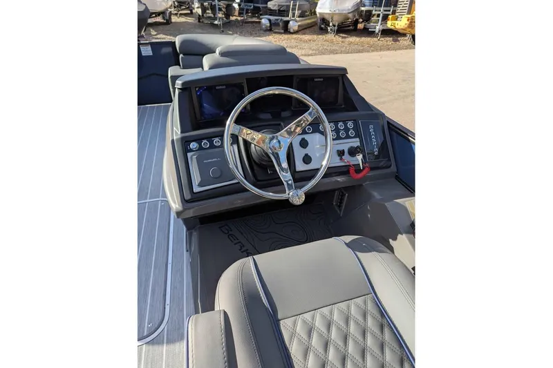 Slide: The Image of 2026 Berkshire 23RFX STS boat dashboard with steering wheel and controls. - 12