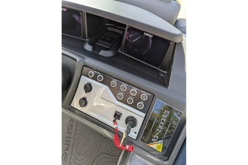 Slide: The Image of 2026 Berkshire 23RFX STS dashboard with controls and Simrad display. - 13