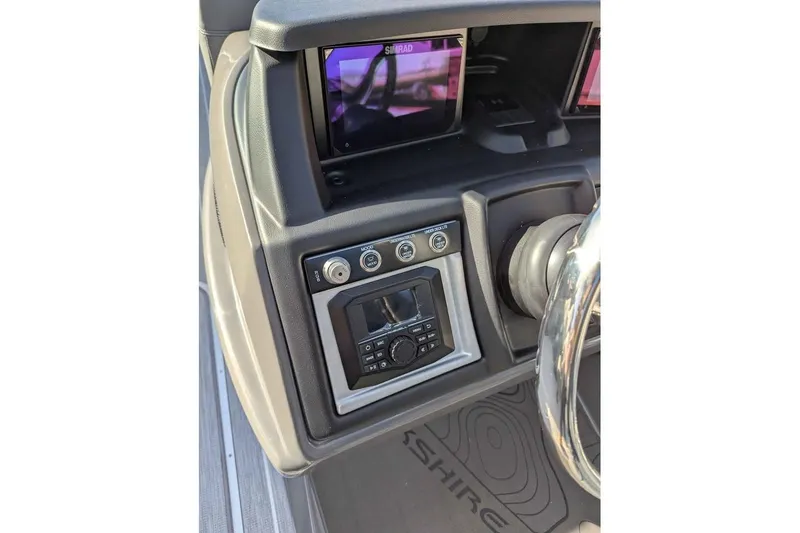 Slide: The Image of Dashboard of 2026 Berkshire 23RFX STS boat with steering wheel and control panel. - 14