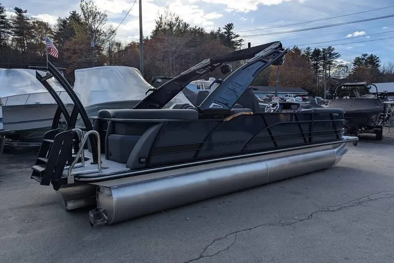 Slide: The Image of 2026 Berkshire 23RFX STS pontoon boat parked outdoors, showcasing sleek design and modern features. - 4