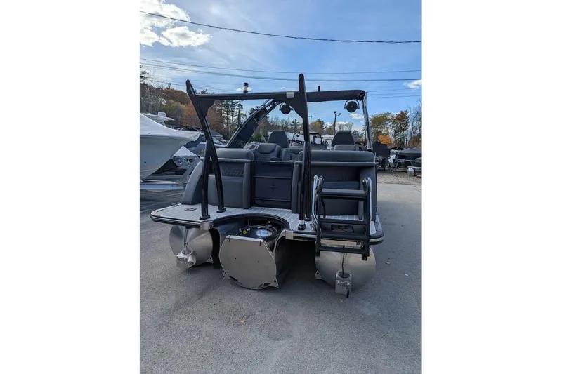 Slide: The Image of 2026 Berkshire 23RFX STS pontoon boat, rear view with ladder and seating, outdoors. - 5