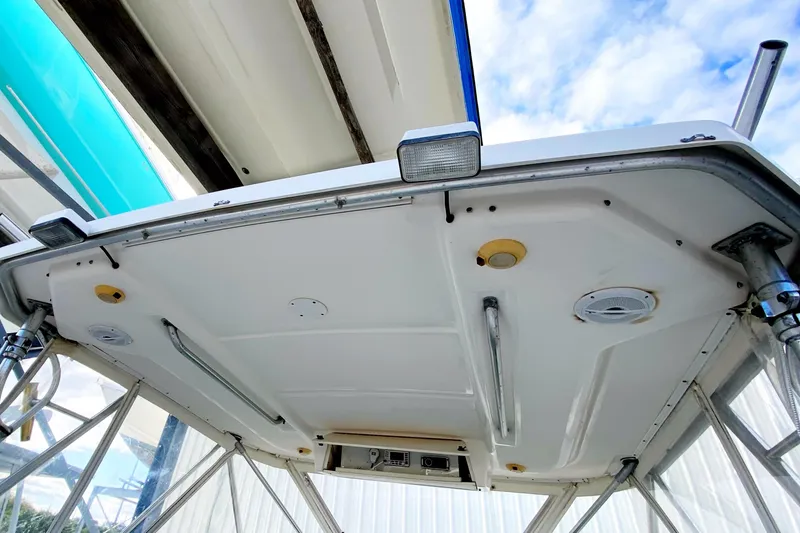 Slide: The Image of 2001 Pursuit 3000 Offshore boat canopy with lights and support poles. - 20