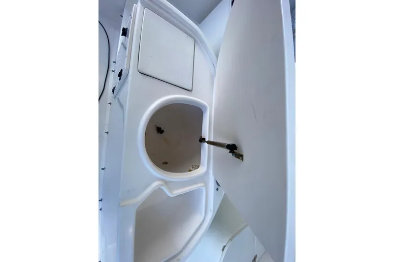 Slide: The Image of 2001 Pursuit 3000 Offshore boat interior storage compartment with open hatch. - 25