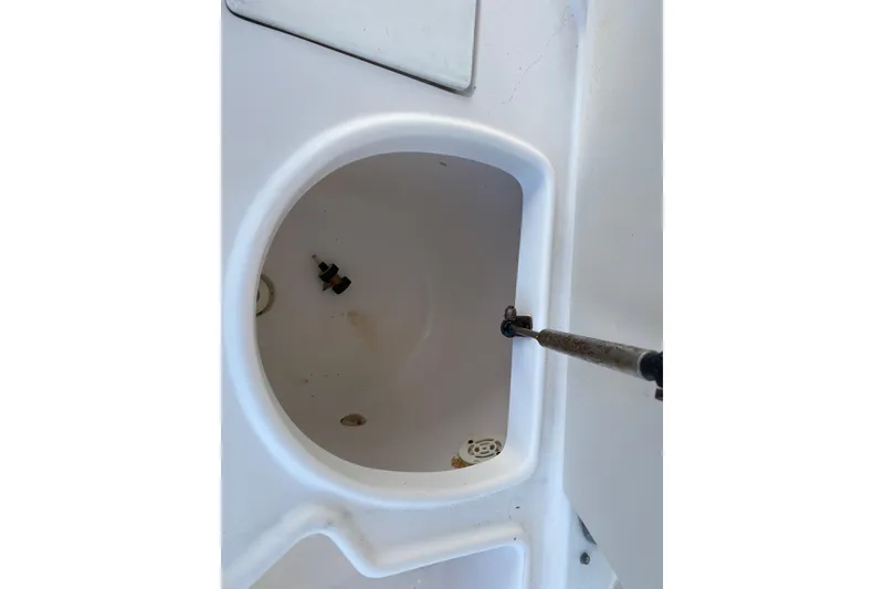 Slide: The Image of 2001 Pursuit 3000 Offshore boat compartment with open hatch and visible hardware. - 26