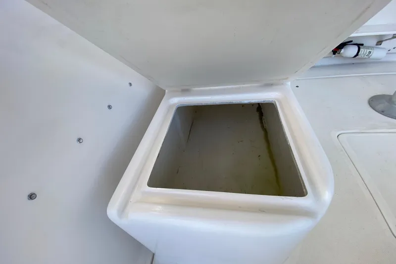 Slide: The Image of Open storage compartment on a 2001 Pursuit 3000 Offshore boat. - 29