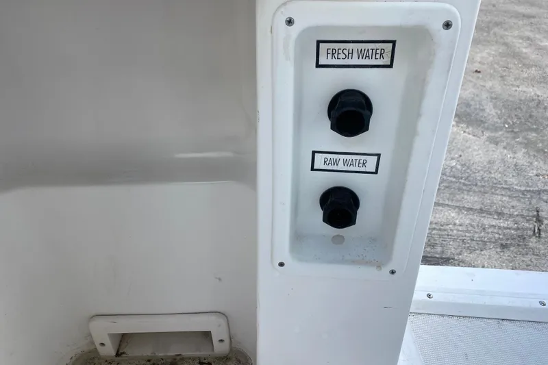 Slide: The Image of Control panel on a 2001 Pursuit 3000 Offshore boat with fresh and raw water switches. - 31