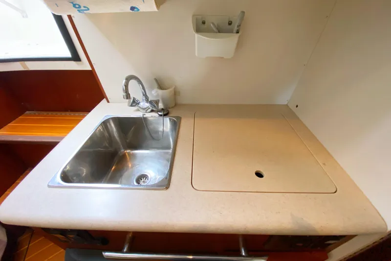 Slide: The Image of 2001 Pursuit 3000 Offshore boat kitchen sink and countertop area. - 43