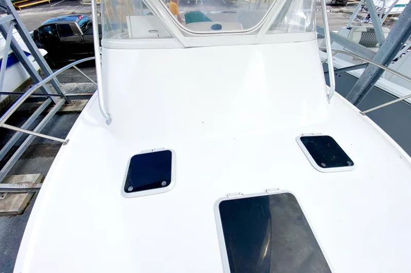 Slide: The Image of 2001 Pursuit 3000 Offshore boat deck with hatches, docked in marina. - 8