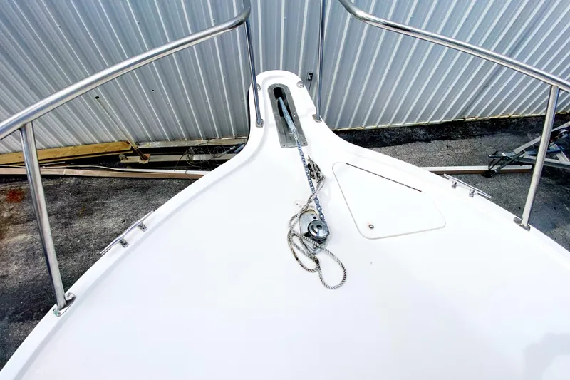 Slide: The Image of Bow of 2001 Pursuit 3000 Offshore boat with anchor chain and railing. - 9
