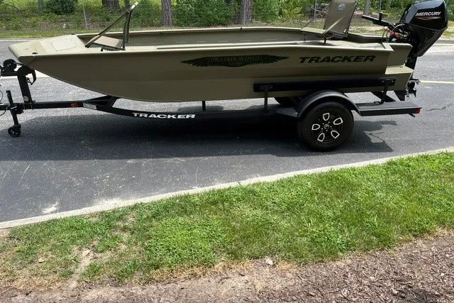Slide: The Image of 2026 Ranger RT198P fishing boat on trailer, featuring Tracker branding and Mercury outboard motor. - 98