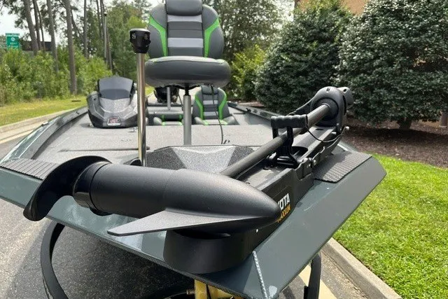 Slide: The Image of 2026 Ranger RT198P boat with trolling motor and seating, parked outdoors. - 2