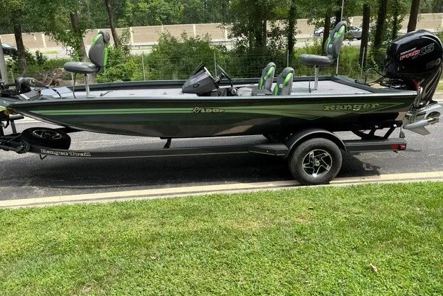 Slide: The Image of 2026 Ranger RT198P fishing boat on trailer, parked outdoors. - 1