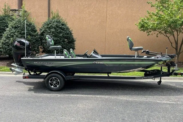 The Image of 2026 Ranger RT198P fishing boat on trailer, parked outdoors. - 0