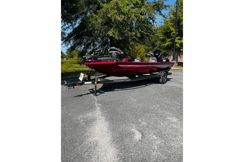 The Image of 2026 Ranger RT178 boat in red, parked on a trailer in a sunny outdoor setting. - 0